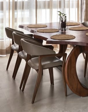 Wooden dining table and chairs by a window